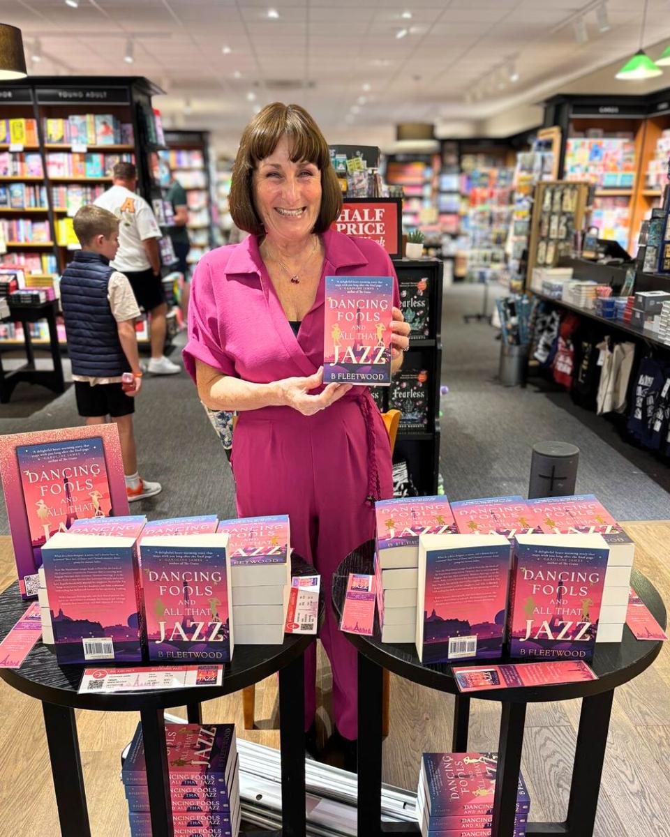 A Book Guild author holding her book in Waterstones