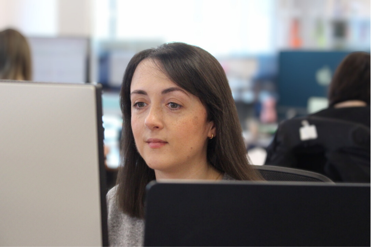 Woman looking at her laptop smiling