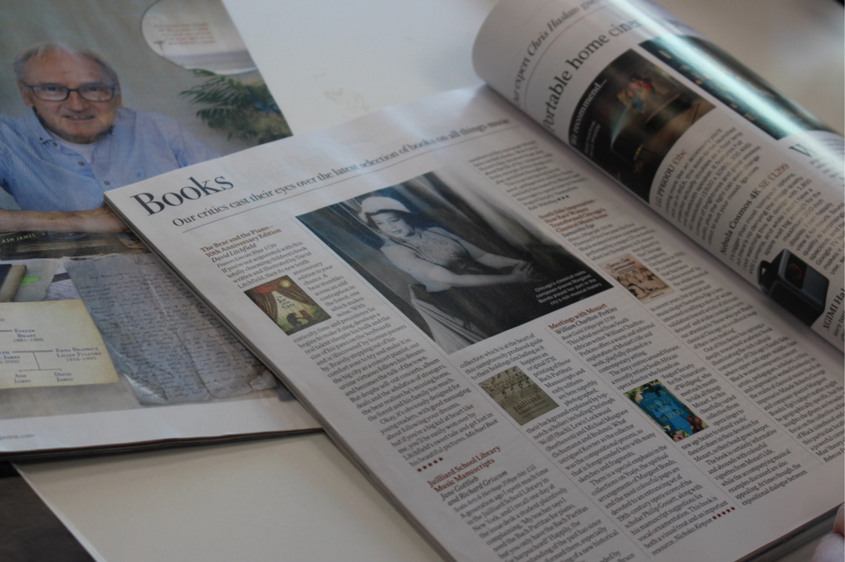 Two magazines, open and displayed book reviews. 